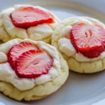 Close-up: Strawberry cheesecake cookies with creamy filling and fresh strawberry slices.