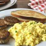 Homemade Jimmy Dean breakfast sausage with scrambled eggs and toast. A hearty and delicious meal!